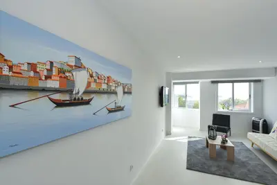 a living room with a large painting of boats at Downtown Prime Porto in Porto