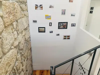 a staircase with photos on the wall at Campanhã Boutique Station in Porto