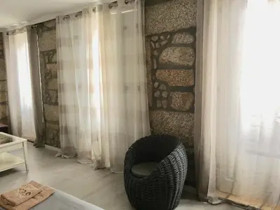 a room with a wicker chair next to a window at Campanhã Boutique Station in Porto