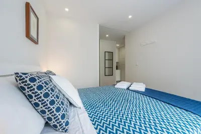 a bedroom with a blue bed with towels on it at GuestReady - Gemini Apartment in Porto