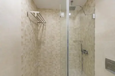 a light fixture hanging from a ceiling in a bathroom at GuestReady - Gemini Apartment in Porto