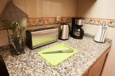 a kitchen counter with a napkin and a toaster at ML Formosa Deluxe Rooms in Porto