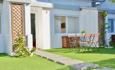 a patio with a table and chairs on a lawn at Porto Garden Villas | Downtown in Vila Nova de Gaia