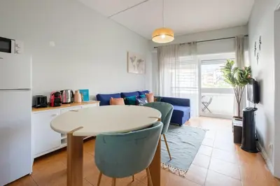 a kitchen and living room with a table and chairs at GuestReady - Back to Little World in Porto