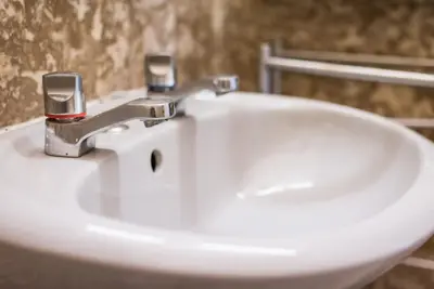 a white sink with a silver faucet in a bathroom at GuestReady - Minimalistic studio downtown in Porto