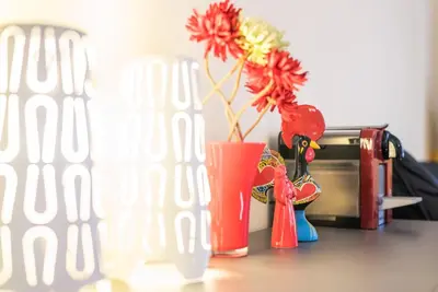 a table with a vase with flowers and a toaster at GuestReady - Minimalistic studio downtown in Porto
