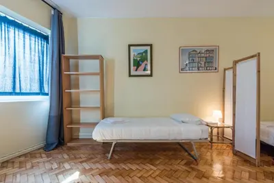 a room with a bed and a book shelf at GuestReady - Minimalistic studio downtown in Porto