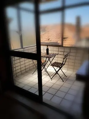 a table and chairs in a room with a window at Quarto com 4 camas (Beliches+ 1 Sofá-cama) in Porto
