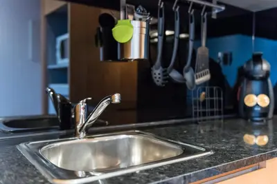 a stainless steel sink in a kitchen with utensils at GuestReady - Given to fly in Porto