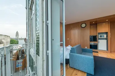 a living room with a blue couch and a window at GuestReady - Given to fly in Porto