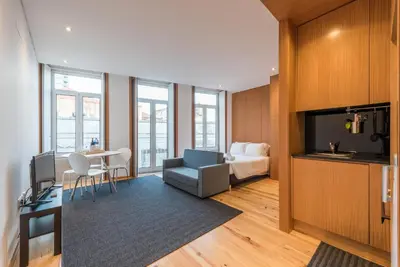 a hotel room with a bed and a tv and a bedroom at GuestReady - Given to fly in Porto