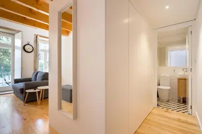 a hallway leading to a kitchen and a living room at Almada Studio 419 in Porto