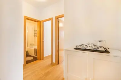 a kitchen with white walls and a counter top at Camões Executive Flat in Porto