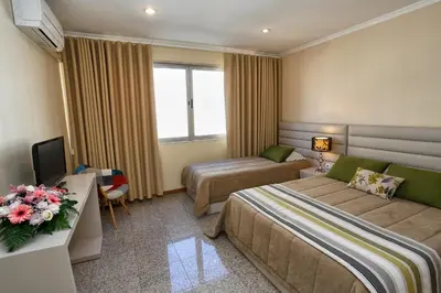 a hotel room with two beds and a television at Oporto City Centre Apartments in Porto