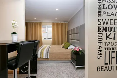 a bedroom with a bed and a desk in a room at Oporto City Centre Apartments in Porto