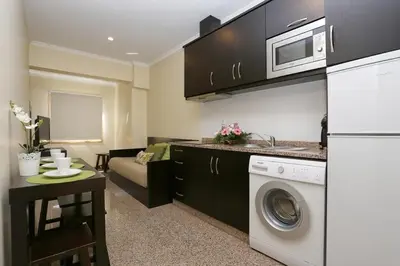 a kitchen with a washer and dryer in a room at Oporto City Centre Apartments in Porto