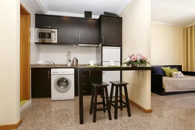 a kitchen and living room with a washing machine at Oporto City Centre Apartments in Porto