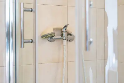 a shower with a shower head in a bathroom at GuestReady - Porto Magic View in Vila Nova de Gaia