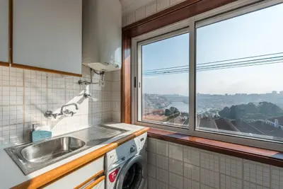 a kitchen with a sink and a window at GuestReady - Porto Magic View in Vila Nova de Gaia