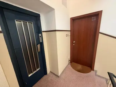 a hallway with a blue door and a wooden door at ML Apartments Almada panoramic balcony in Porto