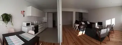 a kitchen and a living room with a table at Porto Nascente in Porto