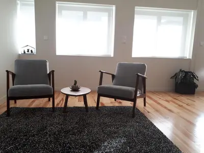 two chairs and a table in a living room at Porto Nascente in Porto