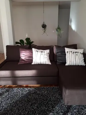 a brown couch with pillows in a living room at Porto Nascente in Porto