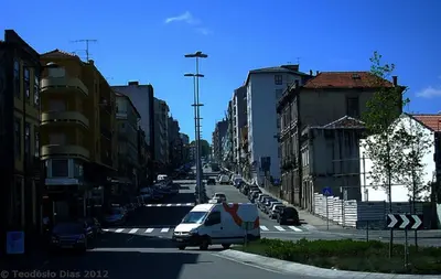 a white van is driving down a city street at Porto Nascente in Porto