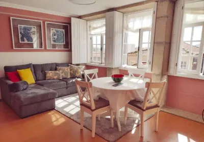a living room with a table and a couch at Oporto Centre Clean & Cozy Apt 2 in Porto