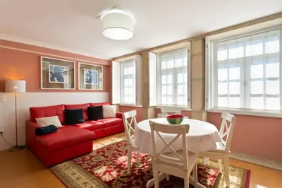 a dining room with a table and a tv on a wall at Oporto Center Clean & Cozy Apt 3 in Porto
