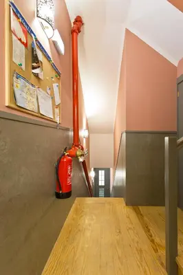 a red fire hydrant sitting on the floor of a hallway at Oporto Center Clean & Cozy Apt 3 in Porto