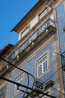 a small bedroom with a bed and two windows at Oporto Center Clean & Cozy Apt 3 in Porto