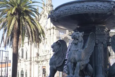 a statue of two lions in front of a building at Oporto Center Clean & Cozy Apt 4th floor in Porto