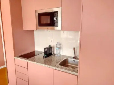 a kitchen with a sink and a microwave at Oporto Centre Clean & Cozy Apt 1 in Porto