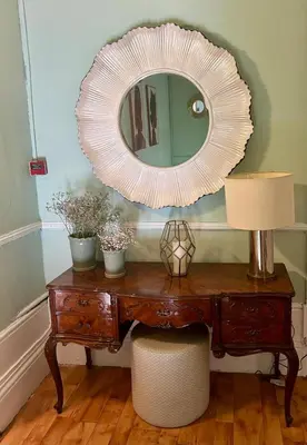a mirror on top of a wooden desk with a lamp at Monte Sinai Guest House in Porto