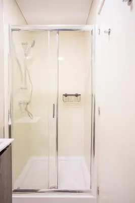 a shower with a glass door in a bathroom at Liiiving in Porto - Historic Clérigos Apartments in Porto