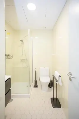 a white bathroom with a toilet and a shower at Liiiving in Porto - Historic Clérigos Apartments in Porto