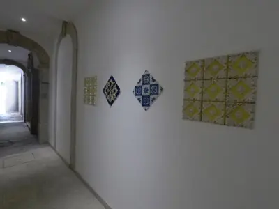 a room with four tiles on a wall at Loft Mártires in Porto