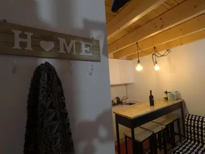 a kitchen with a counter and a table with a counter top at Loft Mártires in Porto