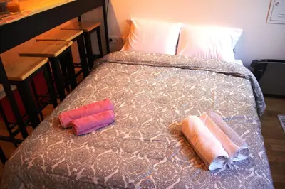 a bed with two pillows on top of it at Loft Mártires in Porto