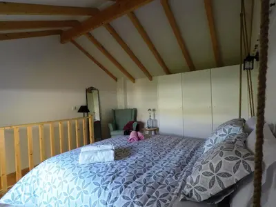 a bedroom with a bed with a blue comforter at Loft Mártires in Porto
