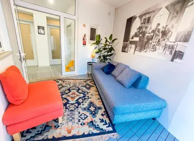 a living room with a couch and a chair at Bluetile Sol Apartment in Porto