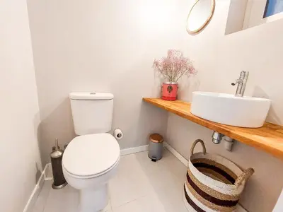a bathroom with a toilet and a sink at Bluetile Sol Apartment in Porto