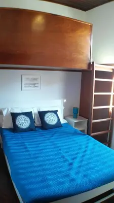 a bed with a blue comforter and pillows in a bedroom at Silver Porto - AL in Porto