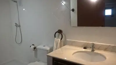 a bathroom with a sink and a toilet and a mirror at Silver Porto - AL in Porto