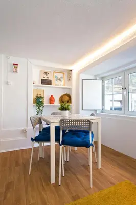 a dining room with a white table and chairs at Oporto Blue Picaria - Unique Citycenter Apartment in Porto