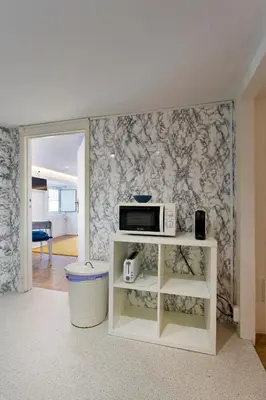 a microwave on a shelf in a living room at Oporto Blue Picaria - Unique Citycenter Apartment in Porto