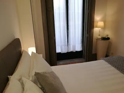 a bedroom with a white bed with a window at Porto Tropical Charm in Porto
