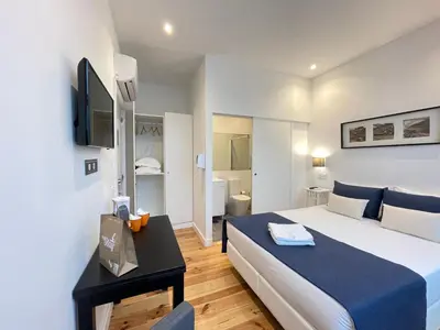 a kitchen with a sink and a room with a bed at MyStay Porto Centro in Porto