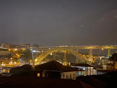 a view of a bridge at night with lights at Porto Views & Wines by Porto City Hosts in Vila Nova de Gaia